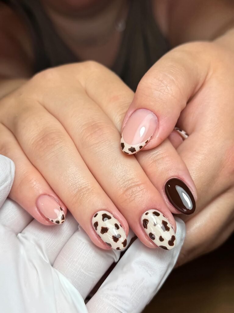Short Brown Cow Print Nails with a Glossy Accent